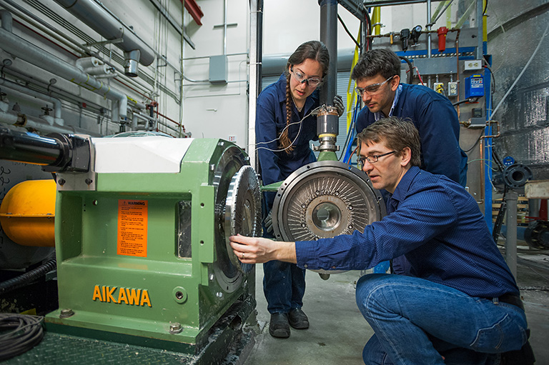 James Olson, Francisco Fernandez and Nici Darychuk examine the installed refiner plate prior to experimentation. Photo credit: Martin Dee